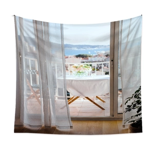 Detail showing high-quality polyester tapestry with sea view balcony and floral table scene
