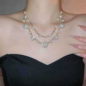 Close-up of double layer pearl necklace with gold plating and sparkling zircon pendants