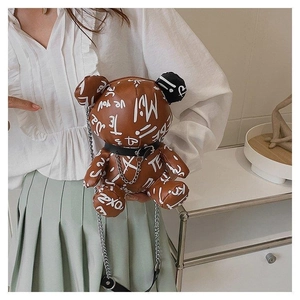 Detail of brown bear crossbody bag with graffiti print and metal chain strap