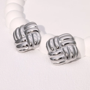 Macro detail of silver square braided texture earrings in polished stainless steel