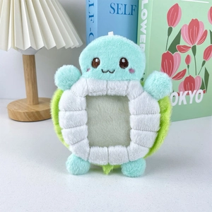 Close-up of cute light blue plush turtle card holder featuring a clear photo window
