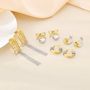 Elegant gold and silver mixed heart earrings set featuring tassels and crystals on silk