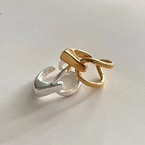 Intertwined gold and silver geometric link rings with modern minimalist finish