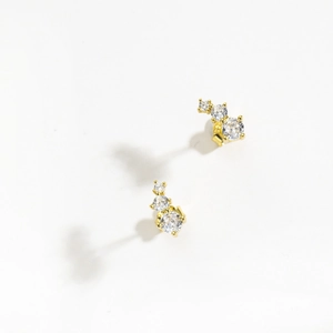 Detailed view of gold S925 sterling silver earrings with three sparkling curved cubic zirconia