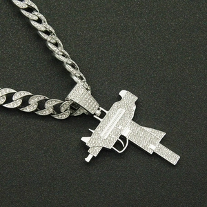 Iced out gun pendant necklace with silver Cuban chain for hip hop and streetwear fashion