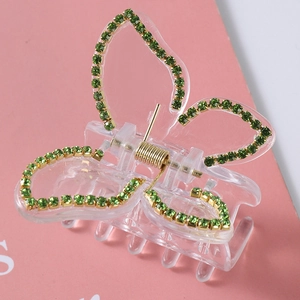 Elegant transparent butterfly hair claw with green rhinestones and golden spring detail