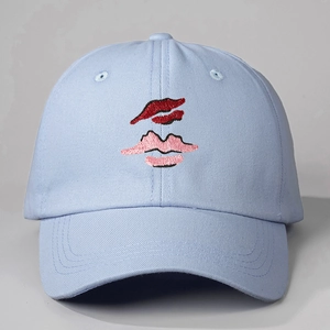 Light blue cotton baseball cap with artistic red lips embroidery and adjustable fit