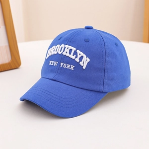 Close-up of white Brooklyn New York 3D embroidery on a navy blue cotton baseball cap