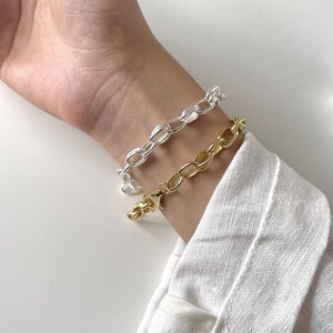 Detail view of 925 sterling silver chain bracelet in gold and silver finish on wrist
