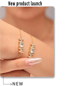 Detail of 18K gold-plated MOM bracelet with zircon heart on a female wrist