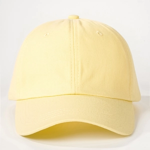 Detail of a light beige cotton baseball cap featuring a six-panel crown and curved brim