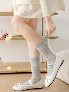 Detailed view of high-elasticity ribbed cuff on grey mid-calf cotton socks