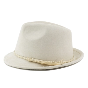 Detail of beige faux suede cowboy hat featuring woven band and elegant tassel trim
