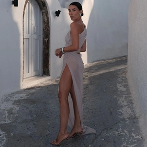 Detail of elegant khaki high-slit dress featuring side cutouts and ruched waist design