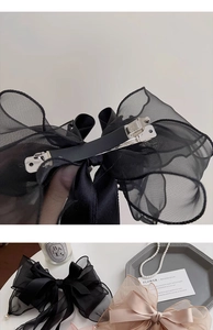 Detail of elegant satin and organza bow hair clip with durable metal spring fastener
