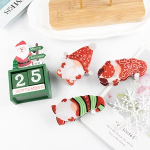 Christmas gnome hair claw clip and wooden Santa calendar decor on a festive background