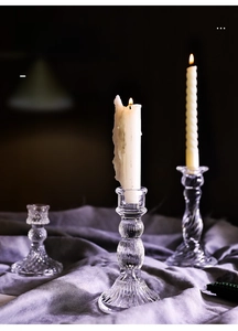 Detailed view of vintage crystal glass candle holders with ribbed and diamond patterns