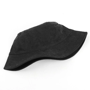 Close-up of black corduroy bucket hat showing fine ribbed texture on white background