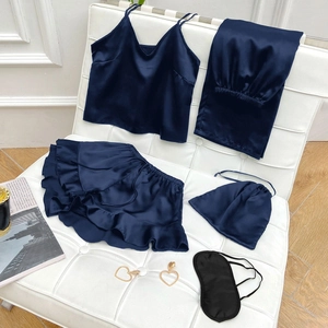 Detailed flat lay of dark blue satin 5-piece sleepwear set with pants and eye mask