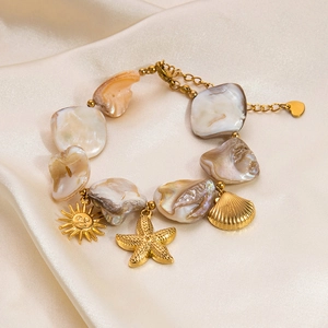 18k gold plated stainless steel bracelet featuring shell beads and ocean themed charms