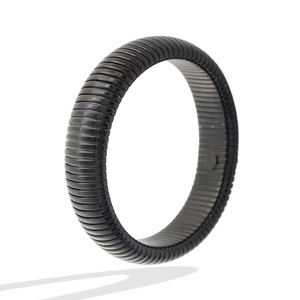 Detailed view of the black titanium steel bangle featuring a ribbed tubular texture