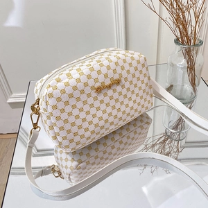 Elegant white square crossbody bag with yellow geometric pattern and gold chain strap