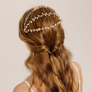Detailed back view of a gold baroque headband featuring pearls and floral rhinestone accents