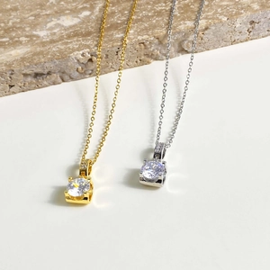 Elegant gold and silver stainless steel necklaces with four-prong cubic zirconia pendants