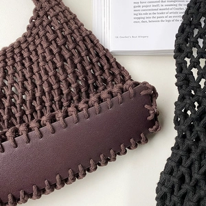 Close-up of brown woven tote bag showing cotton rope mesh texture and faux leather strap