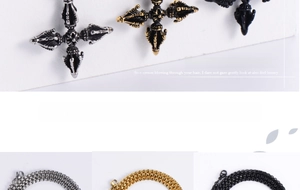 Close-up of vintage Vajra cross pendant with detailed embossed textures in three colors