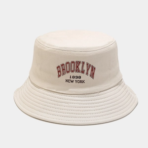 Detail of Brooklyn 1898 embroidery on cream canvas bucket hat with reinforced stitching