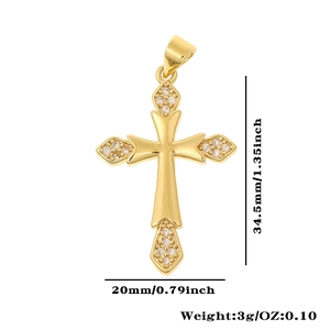 Detailed view of a gold cross pendant with cubic zirconia and exact size dimensions