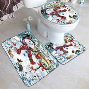Three-piece bathroom rug set featuring snowman holiday theme on wood floor