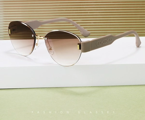 Detail of rimless oval sunglasses with gradient brown lenses and embossed CD temple design