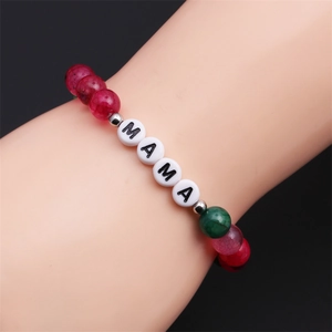 Detail of beaded MAMA bracelet with colorful fire agate stones on woman's wrist