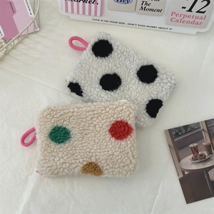 Detailed macro view of plush heart coin purse with polka dot pattern and soft texture