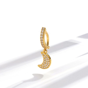 Close-up of golden moon navel piercing belly ring with sparkling clear zircon inlay