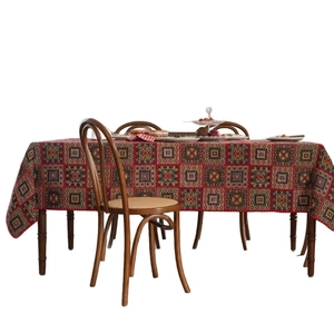 Red geometric jacquard tablecloth with square and diamond patterns for festive dining setup