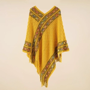 Bohemian knit poncho with yellow geometric pattern and fringe trim for autumn travel