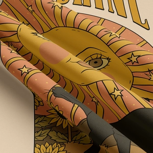 Detail of vintage cat tapestry featuring a sun with sunflowers and star patterns