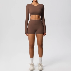 Front view of two-piece dark brown fitness set with long sleeve crop top and yoga shorts