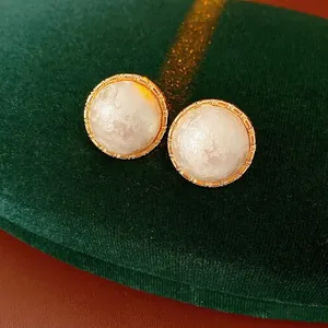 French vintage round gold-plated stud earrings with white cotton pearls on velvet