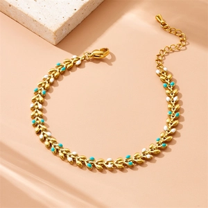 Gold plated stainless steel leaf chain bracelet with blue and white enamel accents
