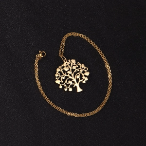 Detailed view of a gold tree of life pendant with heart leaves on a fine cable chain