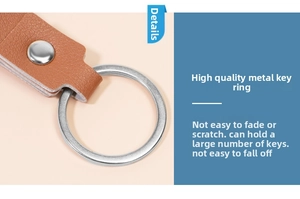 Close-up of brown lychee grain leather keychain with a silver metal ring and rivet