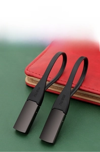 Detail of minimalist silicone car keychain with brushed metal base and menu logo