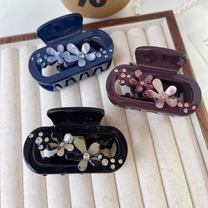 Elegant flower acetate hair claws with rhinestones in blue, purple and black colors