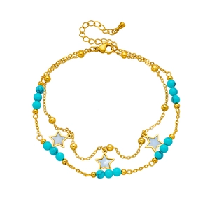 Detail of double-layer gold anklet with blue turquoise beads and white star pendants