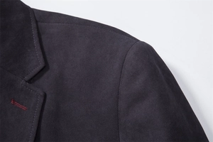 Close-up of shoulder seam and lapel on deep purple slim-fit woolen pea coat