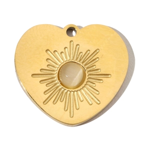 Detail of a gold heart pendant featuring radial sunburst lines and an opal stone center